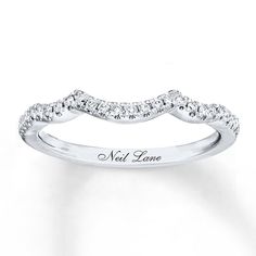 a white gold wedding band with diamonds on the bottom and an inscription that says, not love