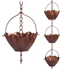 three metal hanging flower pots with chains attached to the bottom and one hanging from the side