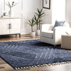 a living room with white furniture and blue rug