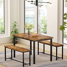 a table with two benches next to it and a painting on the wall behind it