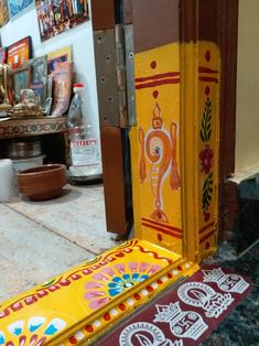 an open door to a room with paintings on the wall and flooring in front of it