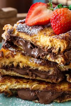 stack of chocolate covered french toast with strawberries on top