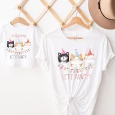 Let's Pawty Cat birthday shirt, Kitty birthday party, girl birthday shirt, Cat party shirt, toddler birthday, Matching Family Shirts Welcome to Christi Creations! Here you will find that unique outfit for a special birthday! We have been in business over 14yrs here on Etsy and can assure you that you will receive 5 Star service! Thank you for supporting our small family business:) Adorable Cat pawty! themed birthday shirts for the birthday child  and matching family members. Unisex Gildan dry bl Playful Fitted Tops For Birthday, 3rd Birthday Cat Theme, Second Birthday Cat Theme, Third Birthday Cat Theme, Cat Birthday Shirt, Kitty Birthday Party, Birthday Party Girl, Kawaii Pink T-shirt With Cat Design, Matching Family Shirts