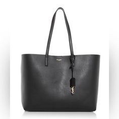 Saint Laurent Shopping Tote In Black East/West Cassandre Charm And Detachable Interior Zipped Purse Leather Lining Gold Toned Hardware Magnetic Snap Closure Dimensions: 14.5” X 11” X 5.1” Handle Drop: 9.2” Made In Italy Note: This Was Purchased In 2021 As A Gift From My Husband. It Comes With The Receipt And All Tags/Cards And The Dustbag Shown. Beautiful Bag, But I Already Have A Few Black Totes And Will Be Purchasing This Again In A Different Color. I Have Only Worn This 4 Times To Work (With Zip Purse, East West, Black Tote, Shopping Tote, Saint Laurent Bag, Beautiful Bags, Womens Tote Bags, Leather Purses, Dust Bag