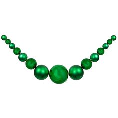 a green necklace is shown on a white background and has five balls attached to it