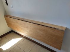 a wooden bench sitting in the corner of a room