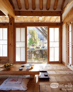 an empty room with wooden floors and large sliding glass doors that open onto the outside