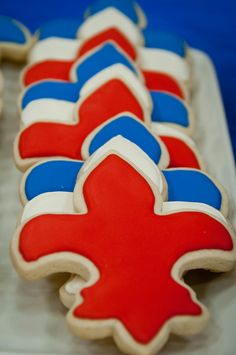 decorated cookies with red, white and blue frosting on a baking sheet in the shape of crosses