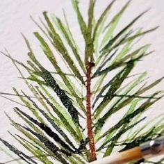 a pencil sitting on top of a green plant