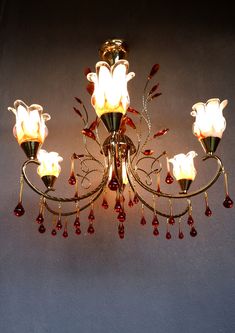 a chandelier with red and white flowers on it