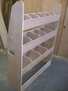 a wooden rack with several compartments on the bottom and one shelf below it that is made out of plywood