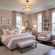 a bedroom decorated in pink and white with a chandelier