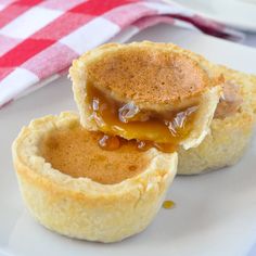 the best butter tarts on a plate with a red and white checkered table cloth