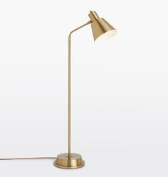 a gold floor lamp on a white background