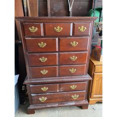 an old wooden dresser with gold handles and knobs