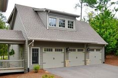 a large house with two garages in the front and one on the other side