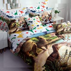 a bed with dinosaurs on it next to a radiator heater and lamp