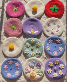 the doughnuts are decorated with flowers and butterflies on top of each other in different colors