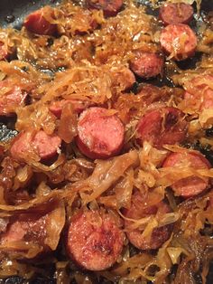 sausage and onions cooking in a skillet