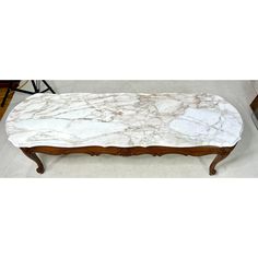 a marble topped bench sitting on top of a hard wood floor