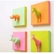 three different types of animal magnets mounted to the side of a wall, each with an elephant and giraffe on them