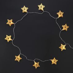 a string of gold stars on a black background