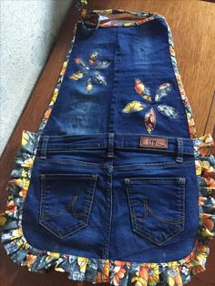 a pair of blue jeans with butterflies on them