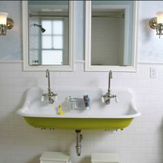 a bathroom sink with two mirrors above it