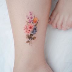 a woman's foot with flowers on it