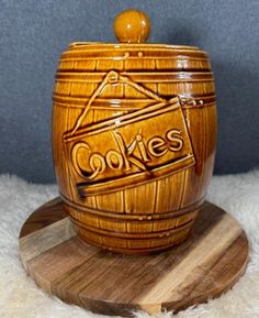 a cookie jar sitting on top of a wooden coaster