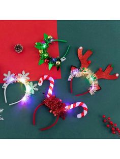 christmas decorations are laid out on a green surface with candy canes and reindeer headbands