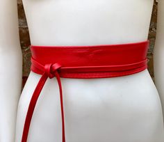 Red waist belt in  genuine leather. Narrower style. Red wraparound belt in soft natural leather. Genuine leather. The color is quite bright, it corresponds to the 6 first pictures of the listing The belt is 220 cm (86 in) long and 5  cm ( 2 in)  at its widest (front) it gets smaller towards the end up to 1 cm (1/2  inch).  Our genuine leather and soft suede obi belts  in different colors: https://www.etsy.com/es/shop/goodtimesbarcelona?section_id=10691564 This listing is for the belt only.  Matc Chic Red Leather Belt, Belt Scarf, Wide Dress, Small Coin Purse, Wrap Belt, Obi Belt, Red Boho, Red Belt, Dress Belt