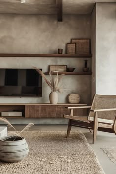 a living room filled with furniture and a flat screen tv on top of a wooden shelf