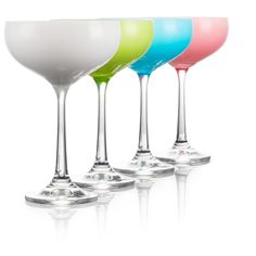 four different colored wine glasses sitting next to each other