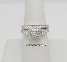 a white gold ring with three princess cut diamonds