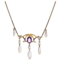 Stylish and finely detailed Art Nouveau drop necklace (circa 1900s to 1910s) crafted in 14 karat yellow gold. One estimated .75 carat amethyst, 6mm x 3.5mm to 9mm x 3mm sawtooth pearls and enamel are set into the necklace. The amethyst is in very good condition and free of cracks or chips. Note: slight chip to enamel. The beautifully made Art Nouveau necklace highlights the faceted center set oval amethyst with accenting purple and white enamel. Natural pearls are set in a fringe style to the ba Gold And Enamel Jewelry, Antique White Gold Necklace, Antique Pearl Necklace, Stile Art, Art Nouveau Necklaces, Detailed Art, Fringe Fashion, Big Diamond, White Gold Necklaces