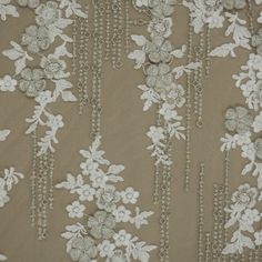 white flowers and chains on brown fabric