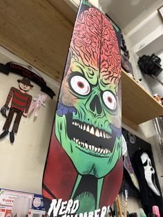 a skateboard with an image of a zombie on it's side in a shop