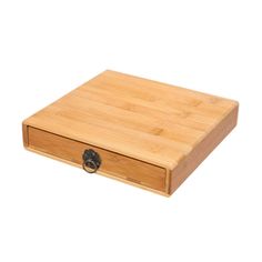 a cutting board with an open drawer on the bottom and two black knobs at the top