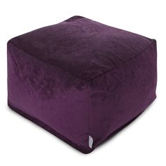 a large purple square pillow sitting on top of a white floor