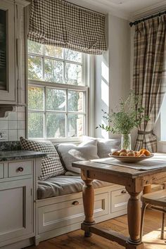 a kitchen table sitting under a window in front of a window with curtains on it