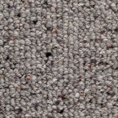 the texture of an upholstered carpet is shown in grey and brown tones with small black dots