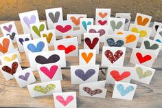 many different colored hearts are displayed on white cards