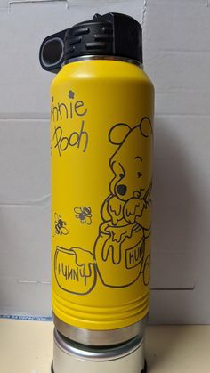 a yellow and black water bottle sitting on top of a white counter next to a wall