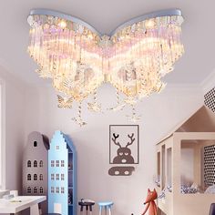 a child's bedroom decorated in pink and blue with a large chandelier hanging from the ceiling