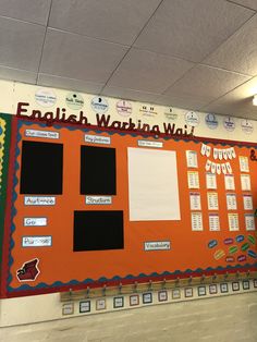 an orange bulletin board with black and white writing on it in a school classroom setting