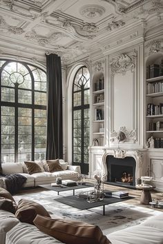 a living room filled with furniture and a fire place in front of two large windows