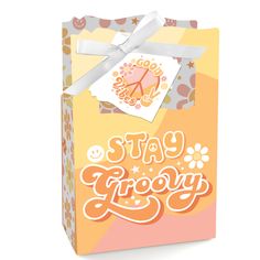 a box with a tag on it that says stay grooy in orange and pink