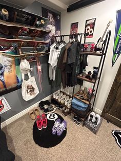 a room filled with lots of shoes and clothing hanging on the wall next to a coat rack