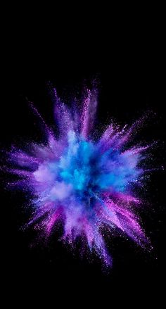 blue and purple powder exploding in the dark